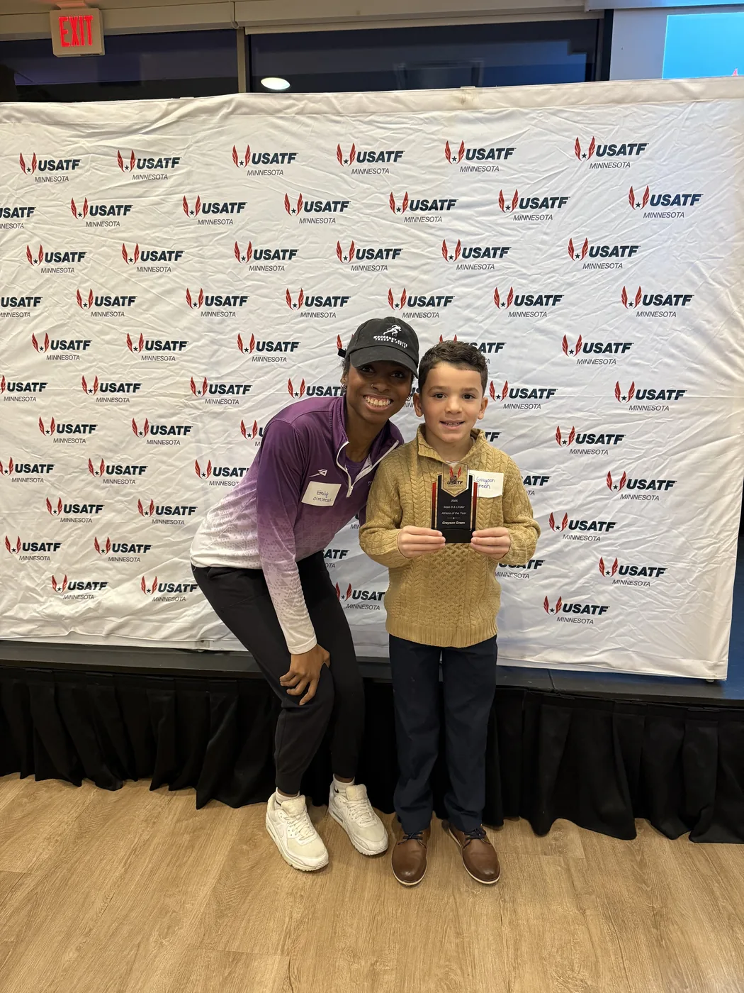 Woodbury Elite athlete and coach holding an award