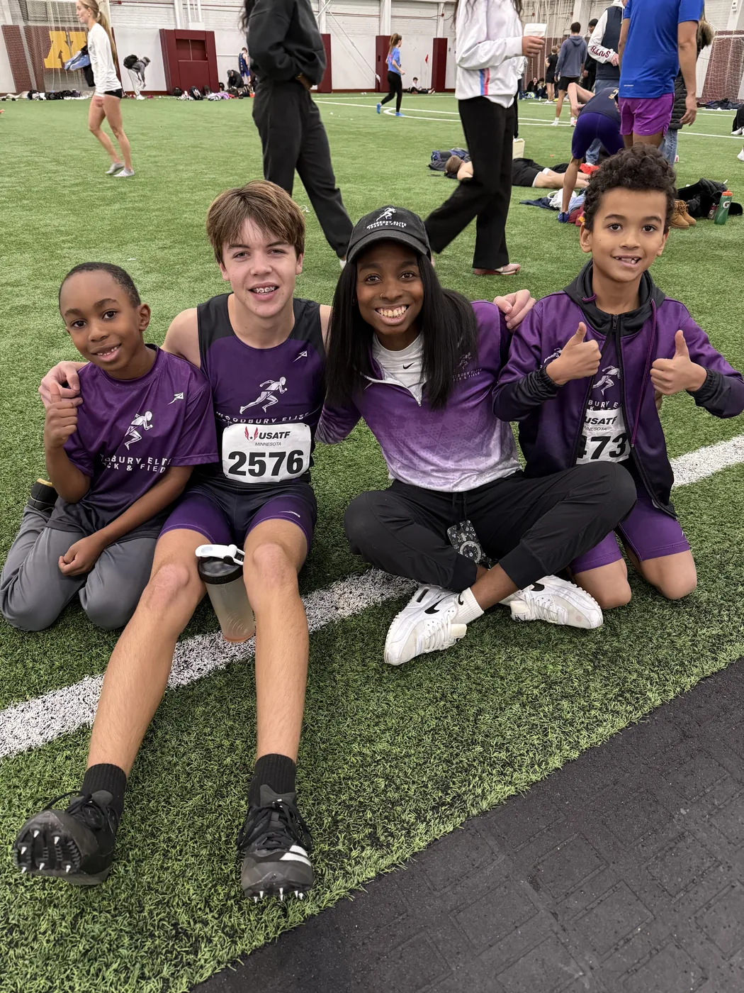 Woodbury Elite athletes and coach together at a meet